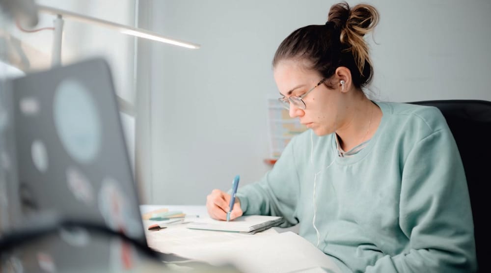 Mujer estudiando frente a su laptop.